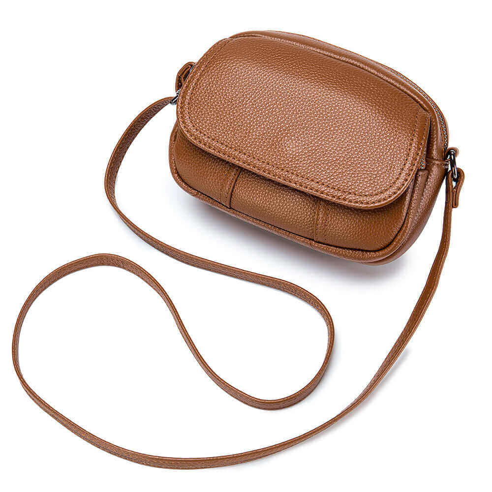 Small round genuine leather bag in brown, featuring a versatile design for shoulder or crossbody wear.