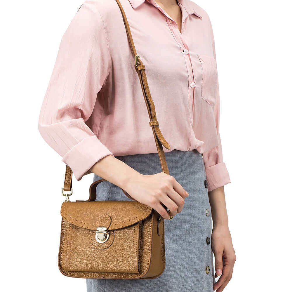 Small vintage messenger bag for women, made from genuine leather with elegant gold details.