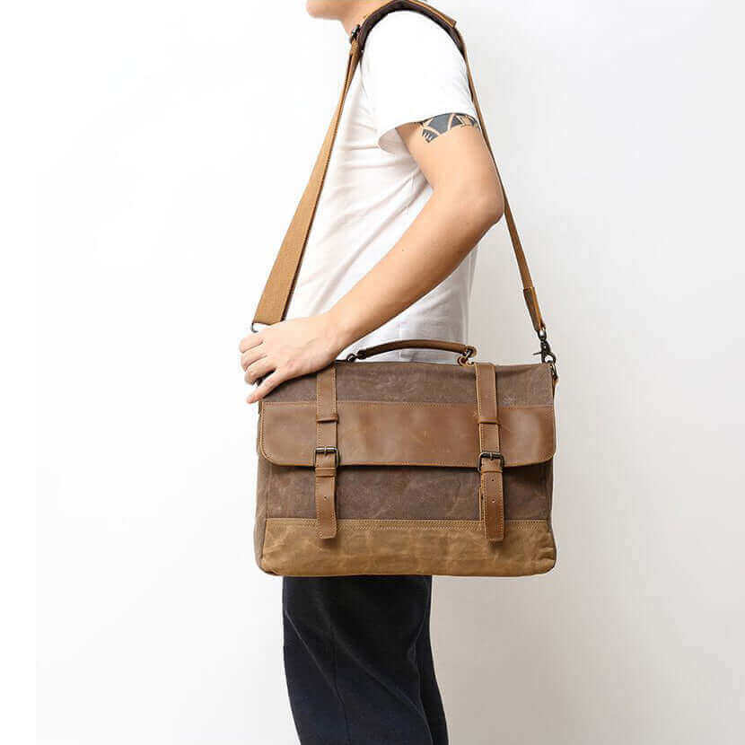 A model wearing the vintage leather and canvas laptop messenger bag, demonstrating its practical use.