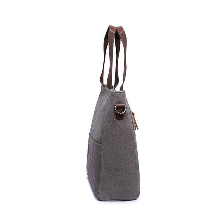 Side view of the women's grey canvas handbag.