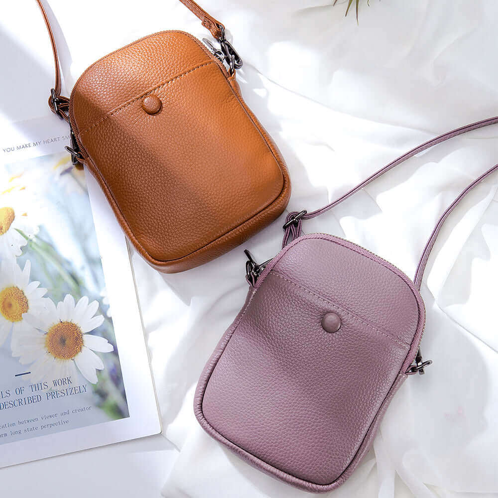 Women's genuine leather mini crossbody bag featuring a decorative leather buckle and compact design.